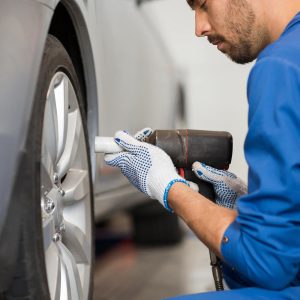 mechanic-with-screwdriver-changing-car-tire-P9CWJFG.jpg mechanic-with-screwdriver-changing-car-tire-P9CWJFG.jpg